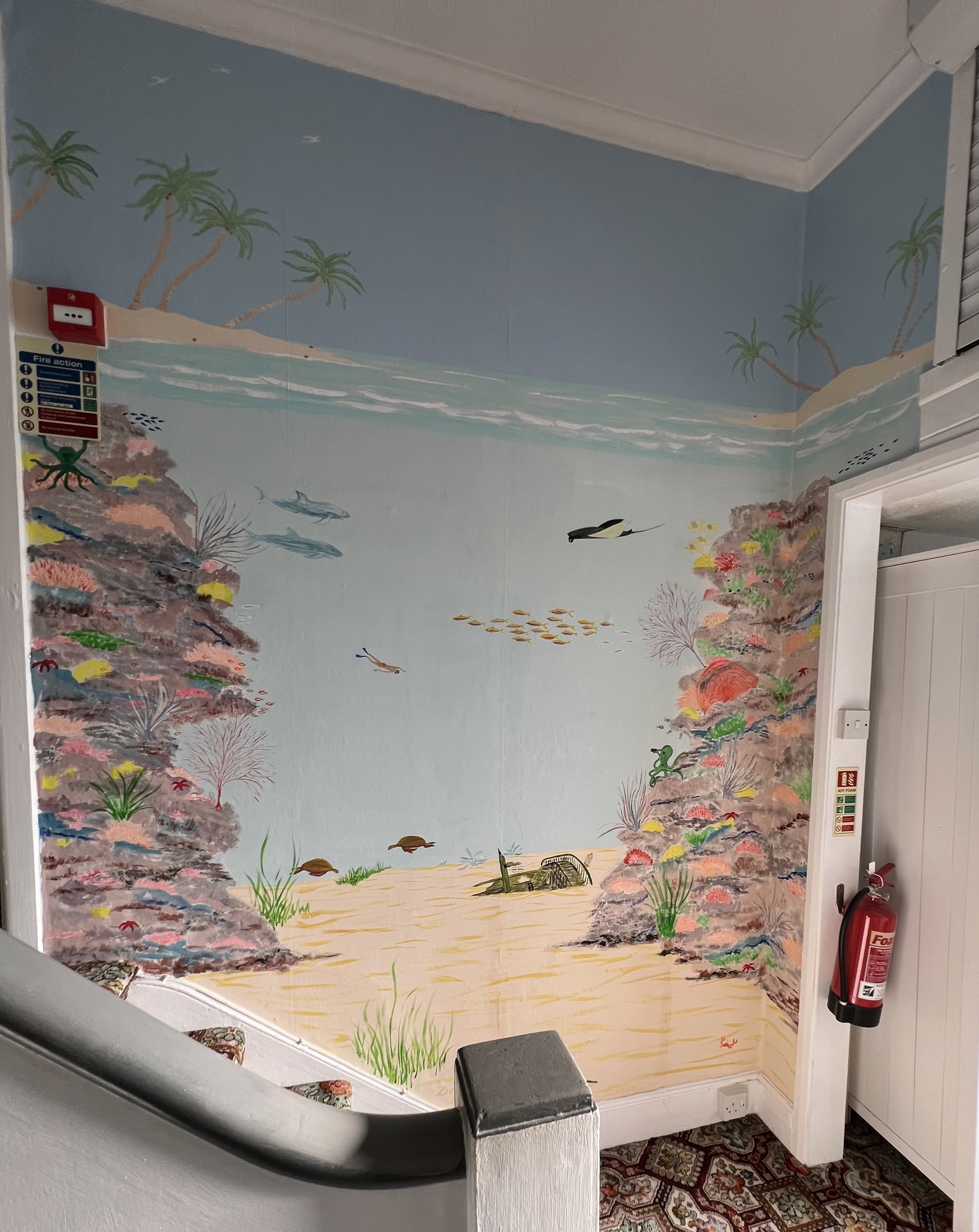 A sea themed mural painted on a wall
